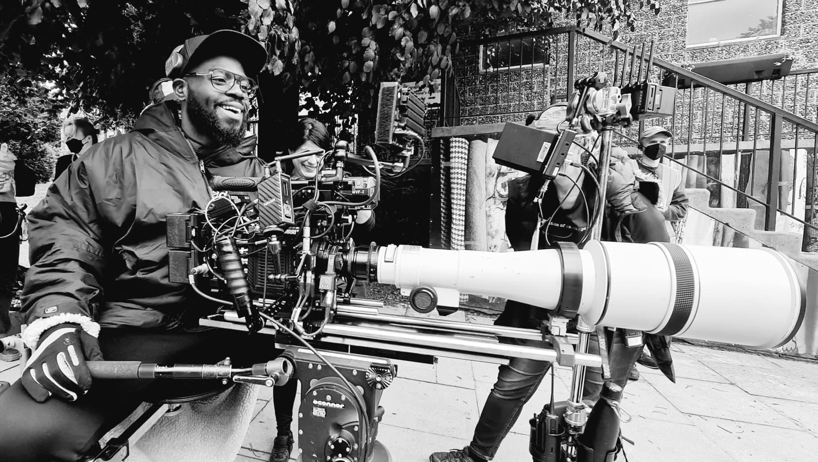 Junior with camera equipment on set